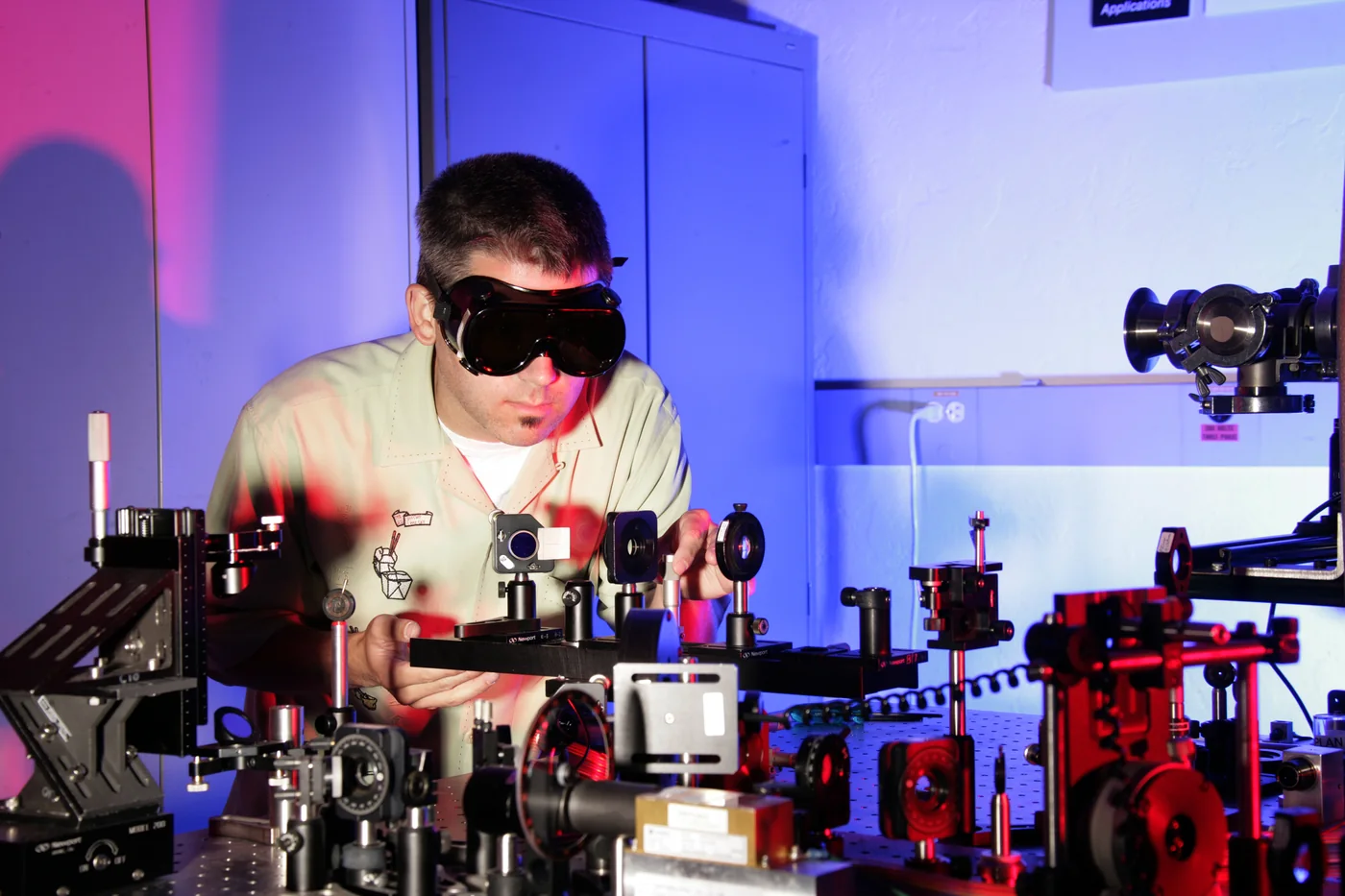 Optical laboratory bench with laser beam paths, mirrors, mounts, and instruments